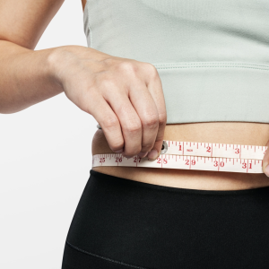 active woman measuring her waist@2x